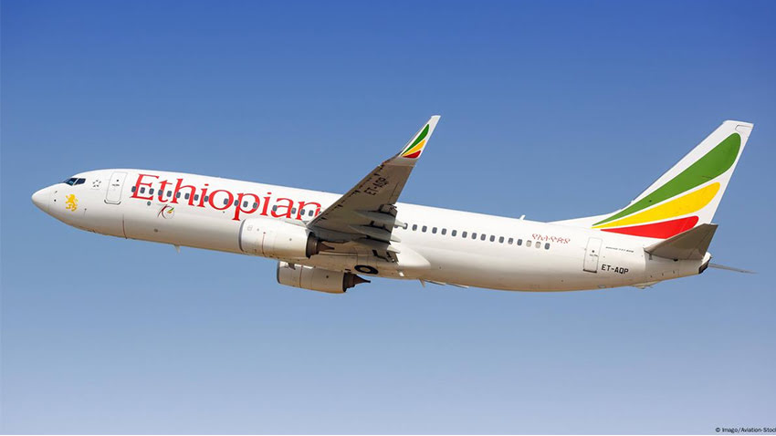 An Ethiopian Airlines airplane flying in a clear blue sky.