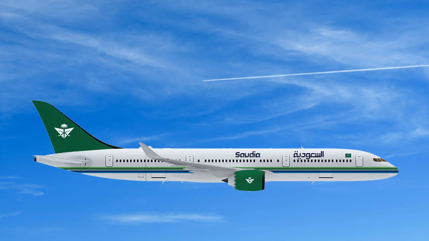 Saudia Airlines aircraft flying in a clear blue sky with a green tail and bilingual branding on the fuselage