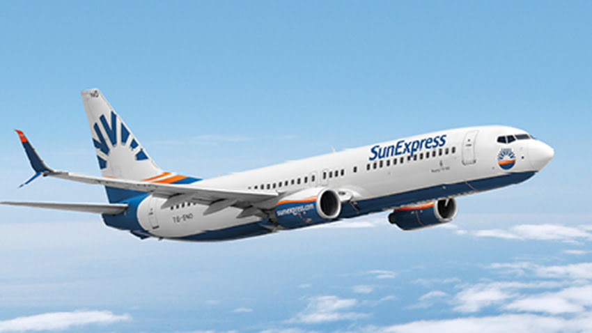 SunExpress airplane in flight above the clouds