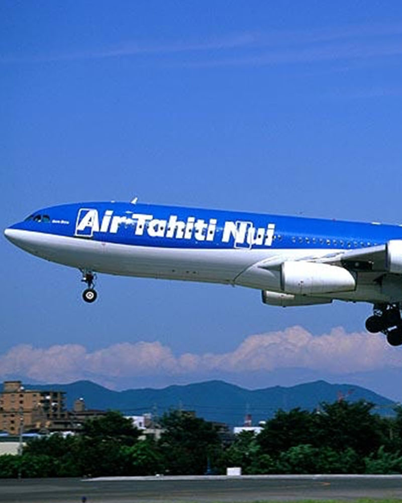 Air Tahiti Nui aircraft taking off under a clear blue sky