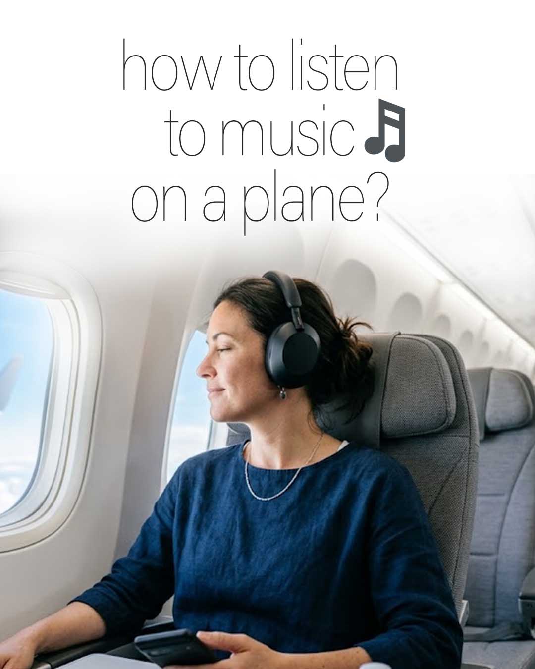 Woman wearing headphones and listening to music on an airplane