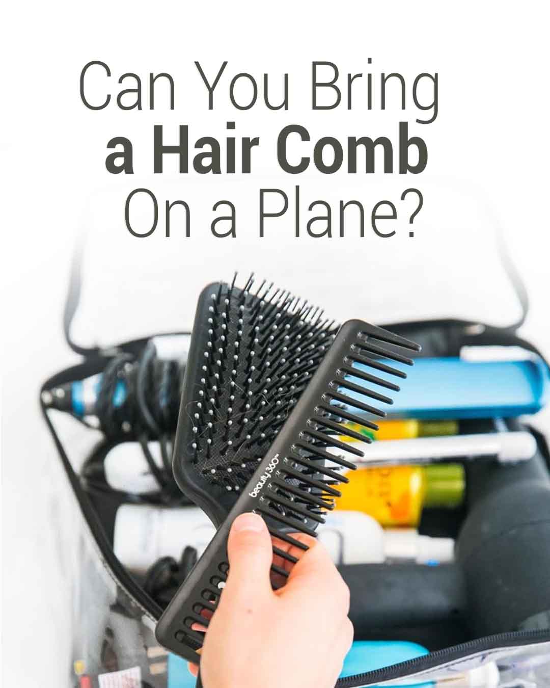 A hand holding a black comb and hairbrush over an open toiletry bag with styling tools