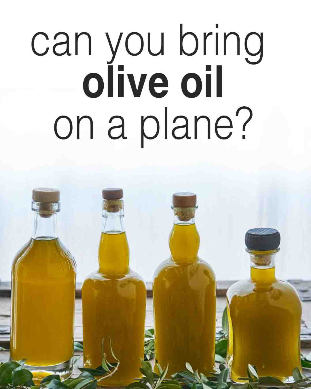 Bottles of olive oil arranged on a table beneath the text “can you bring olive oil on a plane?”