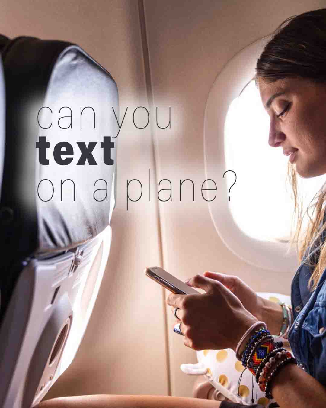 Woman texting on her phone while seated on an airplane