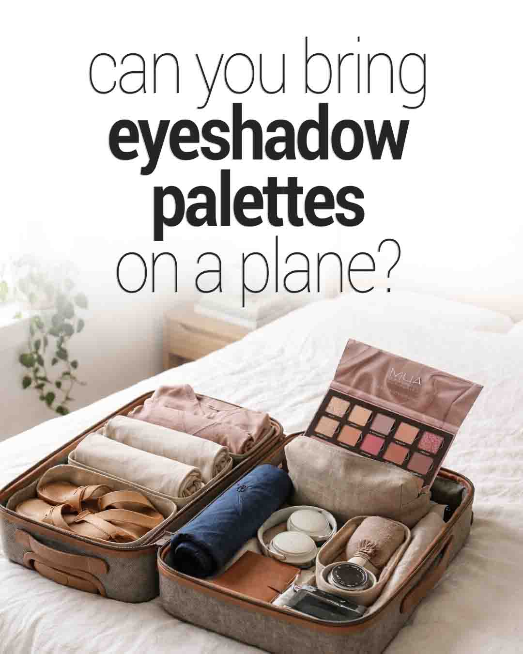 Open suitcase on a bed packed with neatly organized travel items, includingeyeshadow palette displayed prominently
