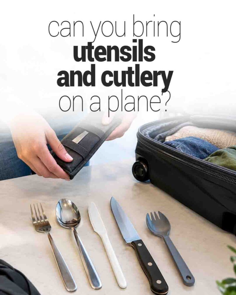 Utensils and cutlery arranged beside an open suitcase