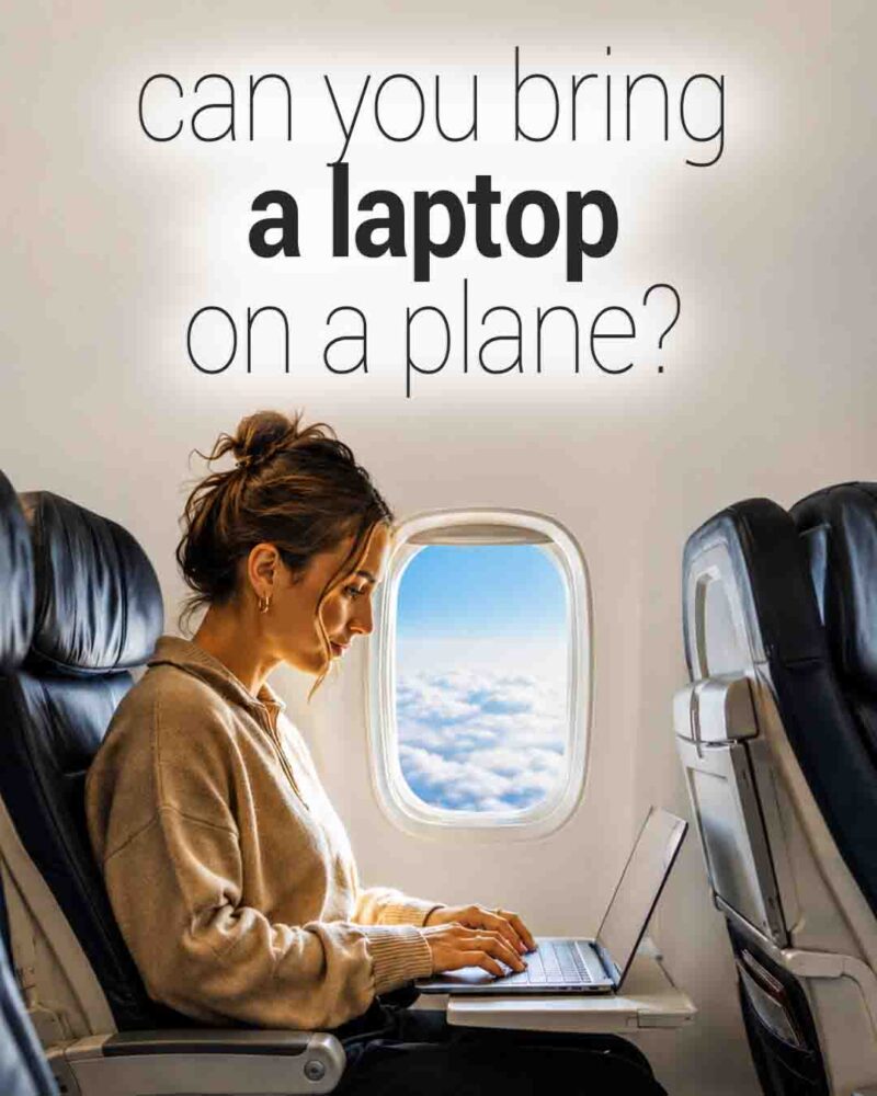Woman seated by an airplane window using a laptop during a flight, with clouds visible outside and text reading, “Can you bring a laptop on a plane?”