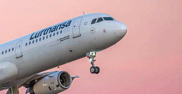 Lufthansa Airbus A321 taking off at sunset