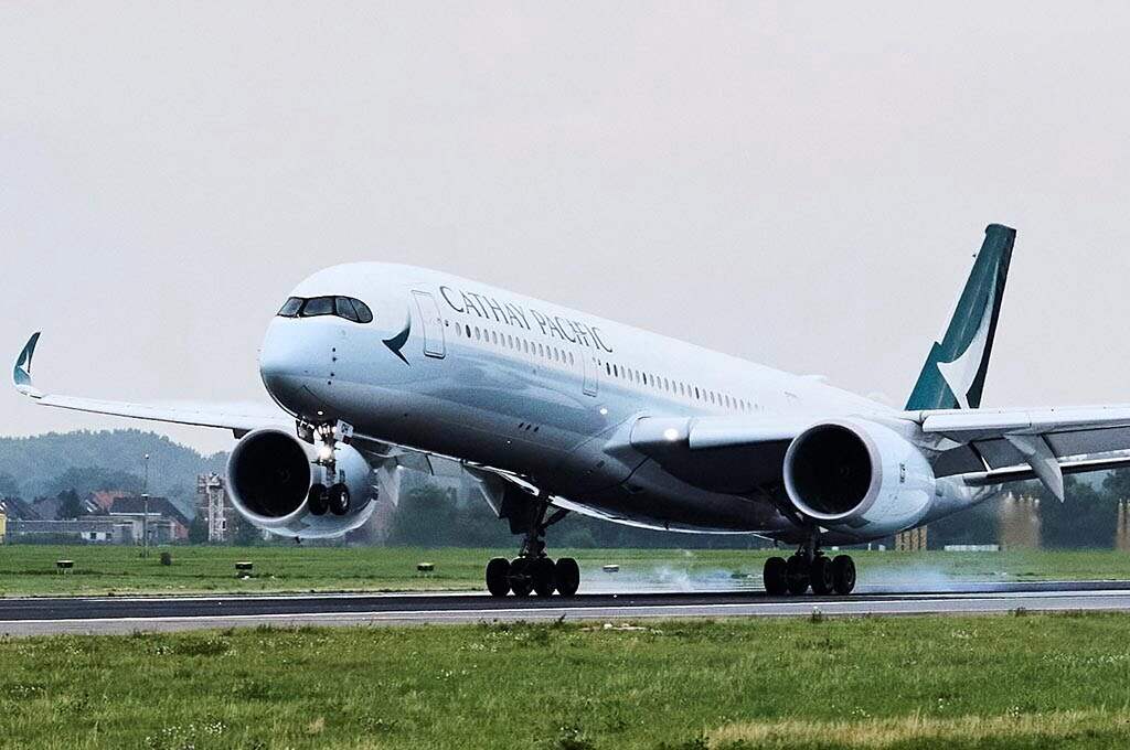 Cathay Pacific aircraft landing on a wet runway