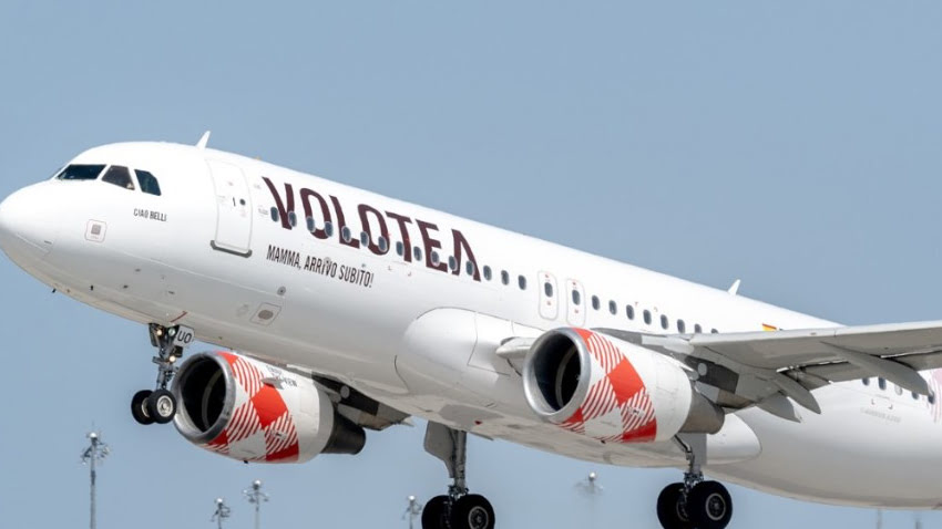 A Volotea aircraft taking off, showing the airline's logo and branding