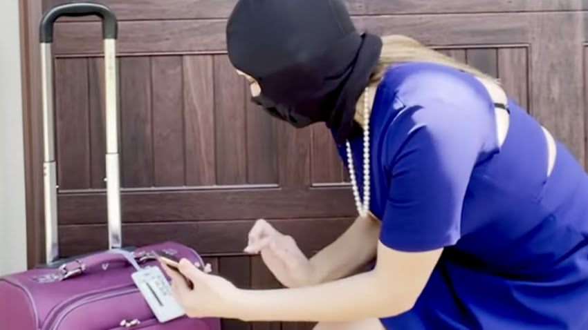 examining a luggage tag on a suitcase