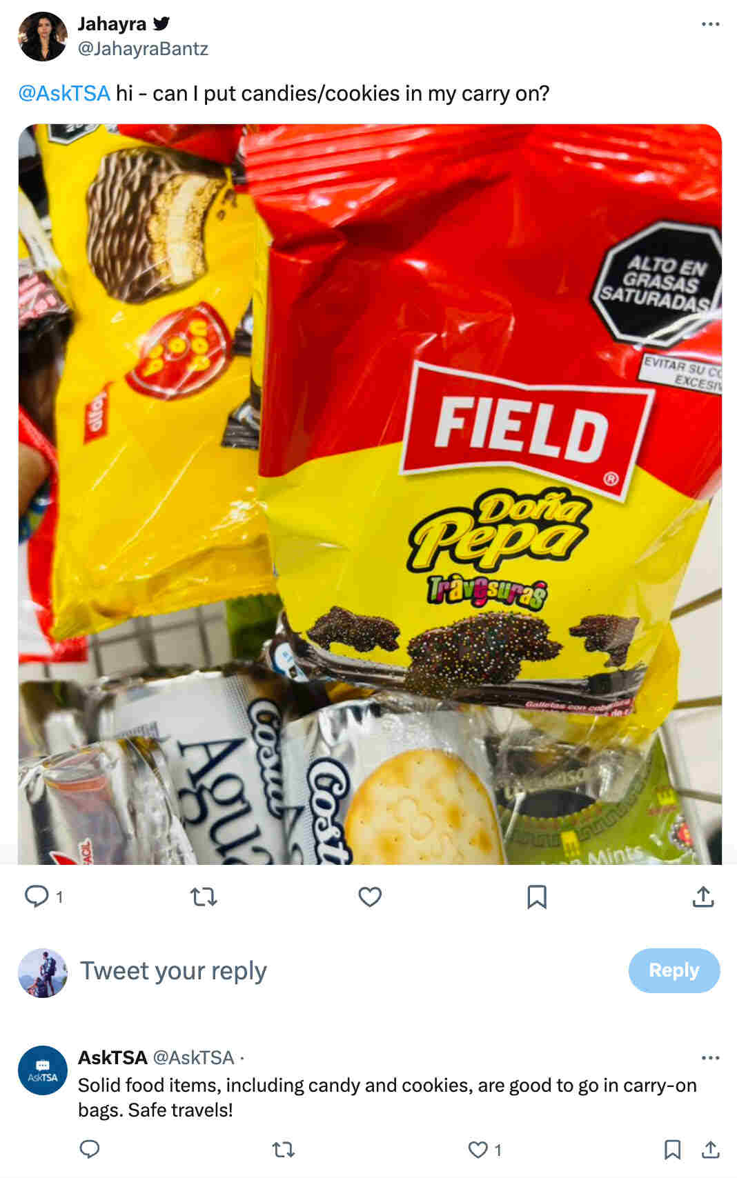 Screenshot of a tweet asking TSA if candy and cookies are allowed in carry-on bags, with TSA confirming that solid food items like those are permitted.