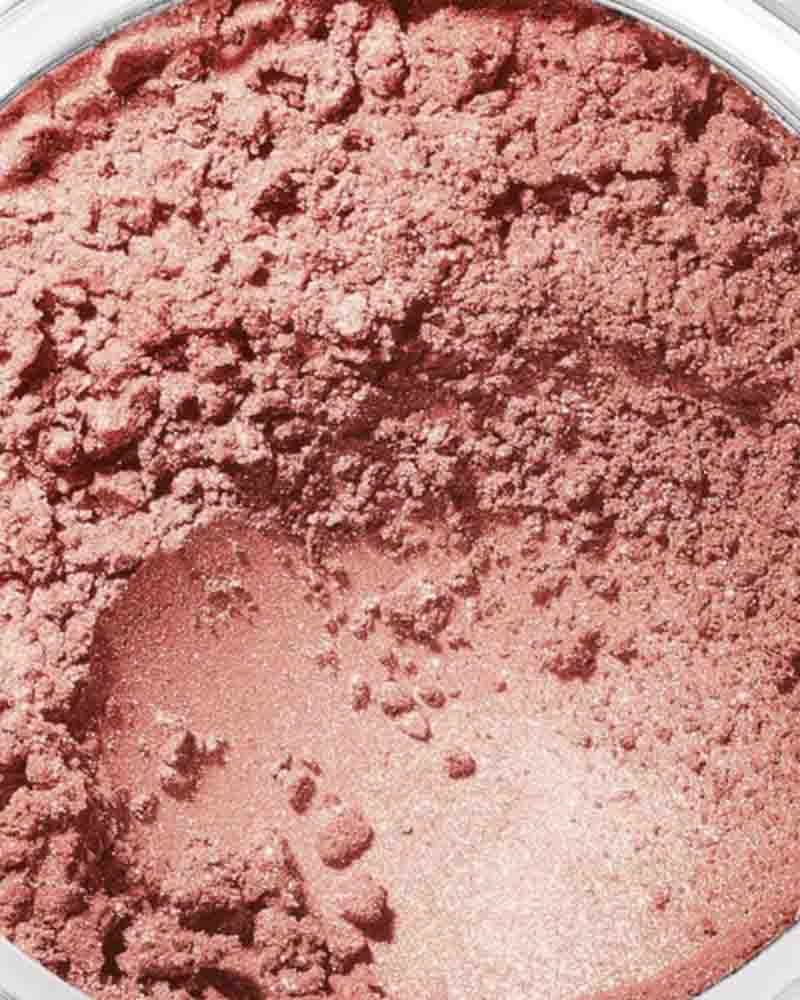 container filled with loose, rosy pink powder