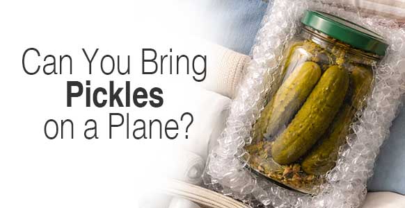 a jar of pickles on a suitcase