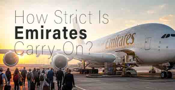 Emirates A380 boarding at sunset with passengers walking to the aircraft